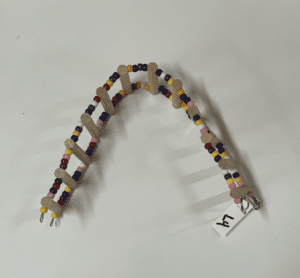 A Large Ladder with beads and a tag on it.